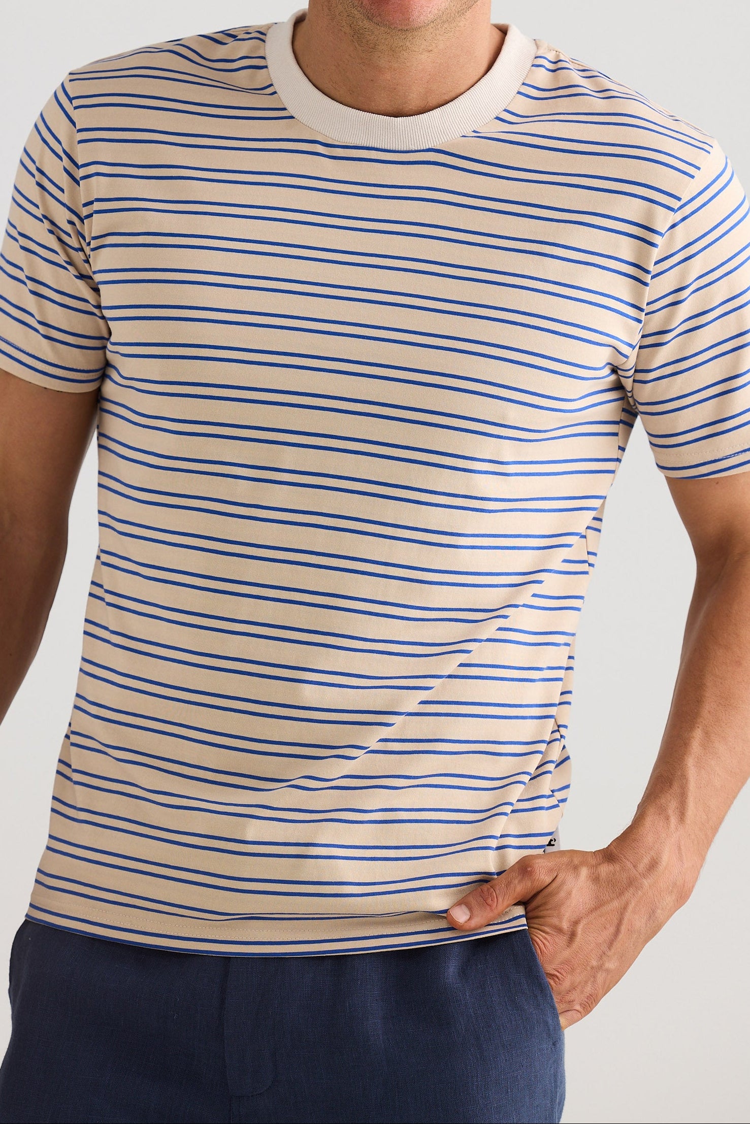 Man wearing a striped t-shirt against a plain background