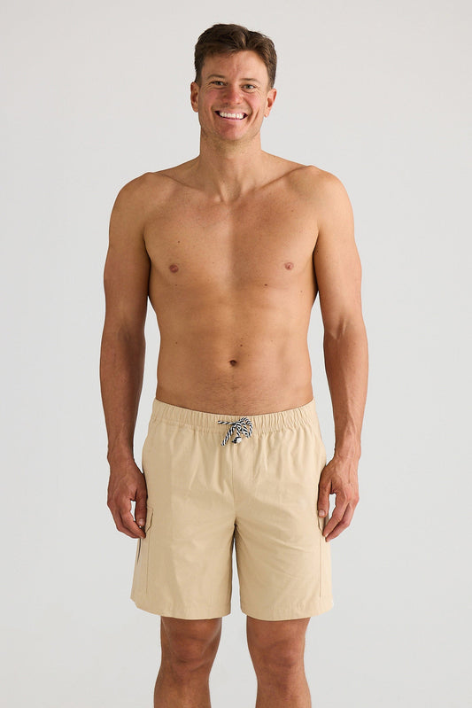 Man wearing beige shorts on a white background