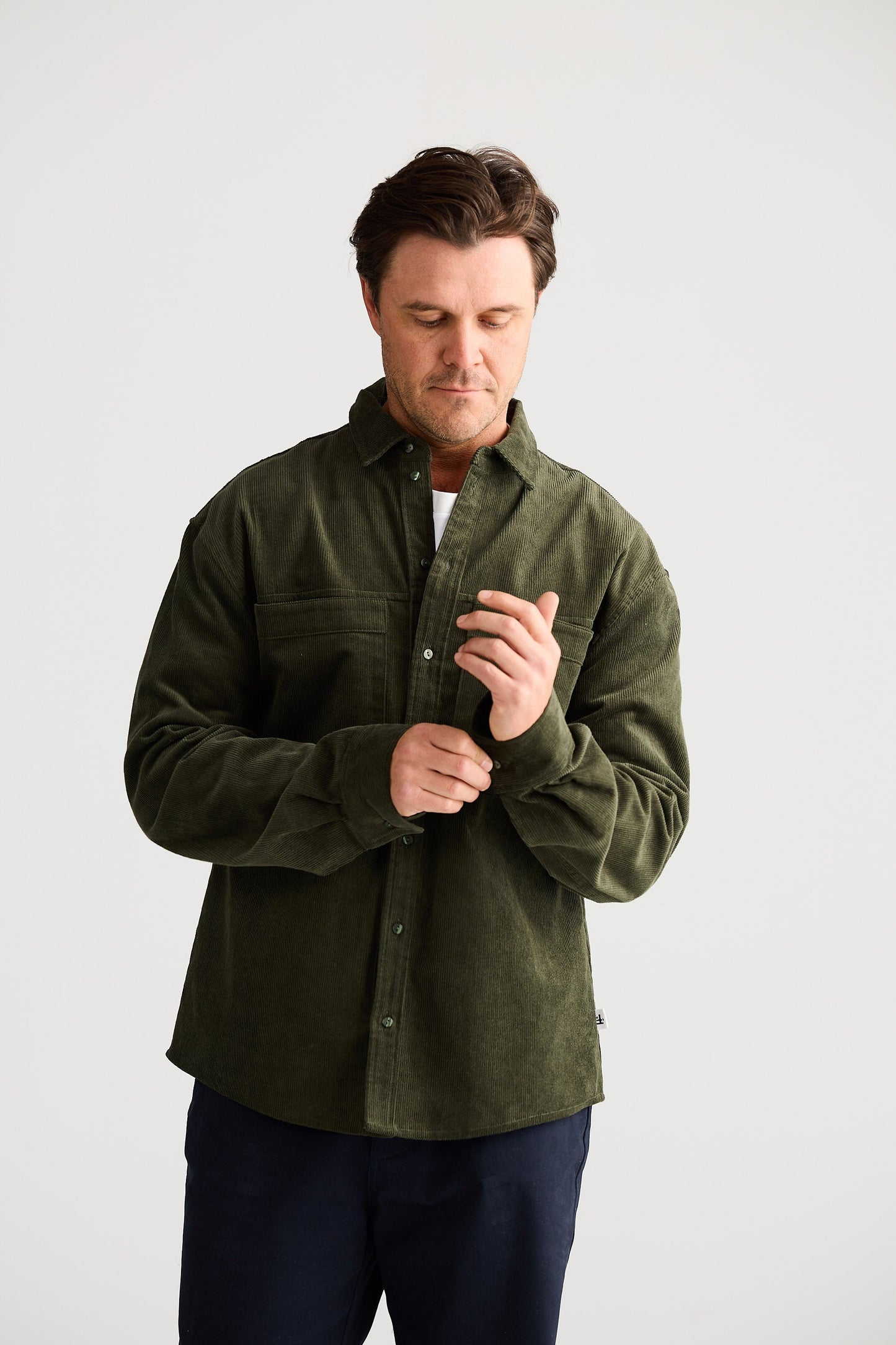 Man wearing a green shirt against a white background