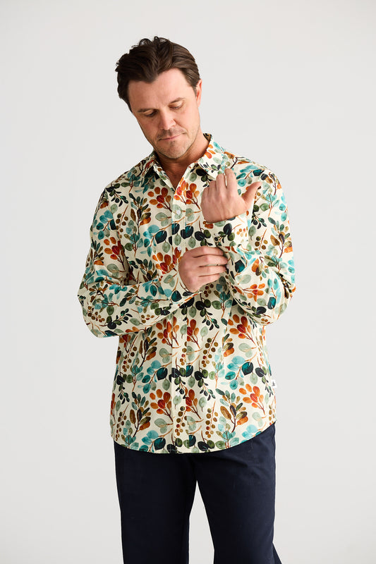 Man wearing a colorful floral shirt against a white background