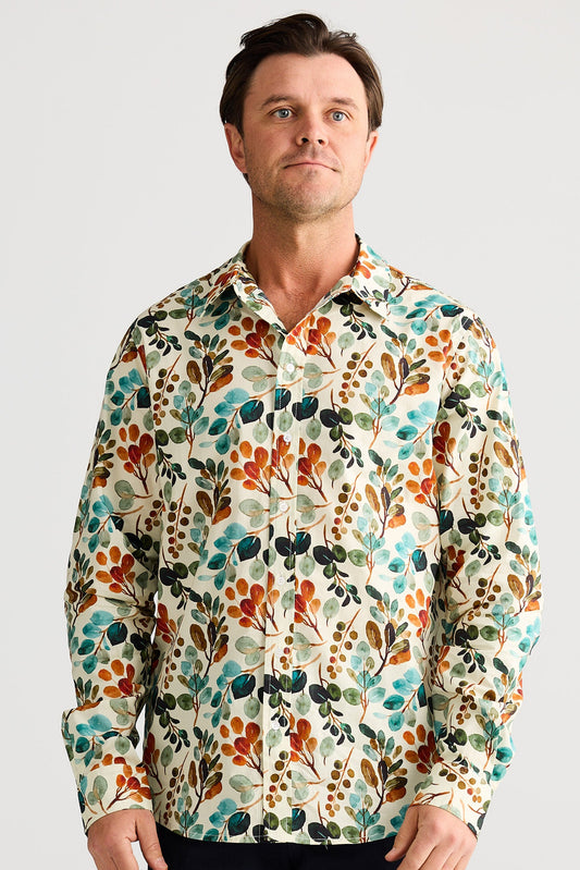 Man wearing a colorful floral patterned shirt against a plain background